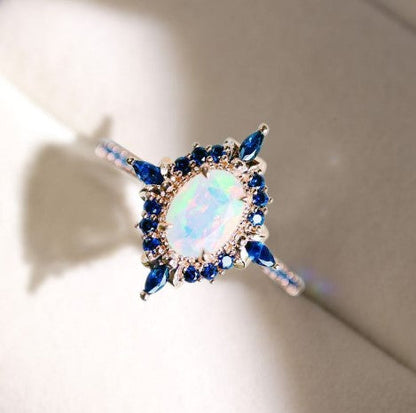 Rose Gold Halo Oval Cut Opal & Blue Sapphire Engagement Ring